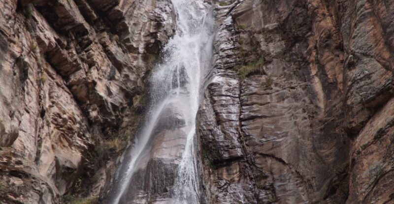 Waterfall cascading down a canyon rock face in the Peruvian Andes