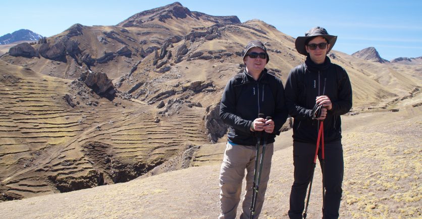 Two Smiling Trekkers standing in front of a Peruvian Mountain