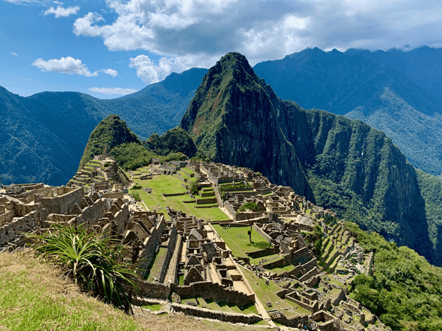 wide picture of Machu Picchu with mountains in the background