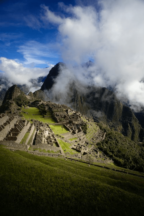 An aerial view of the mountains and the ancient structure of Machu Picchu