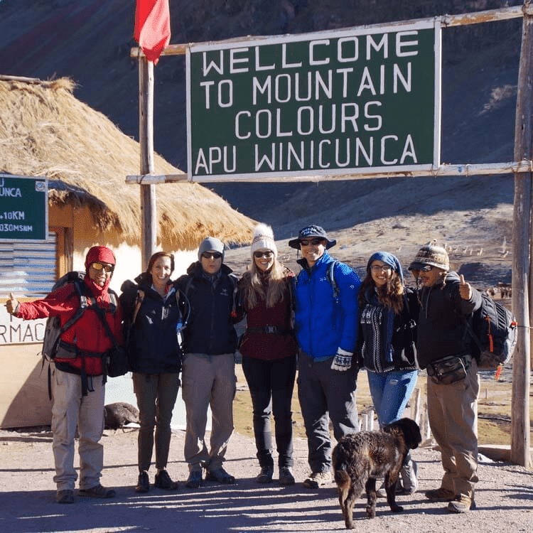 A picture of tourists standing with their tour guide