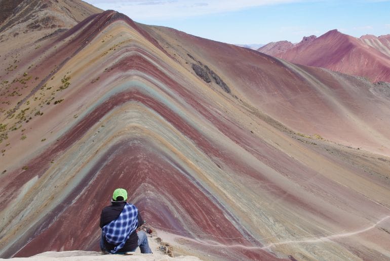 Tourist at Vinicunca showing the Cusco Instagram vs reality contrast