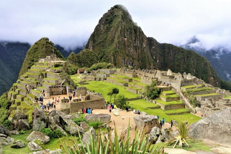 Tourists exploring the Inca citadel of Machu Picchu