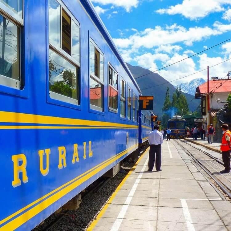 a blue train at a station