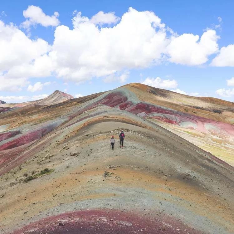 2 tourists trekking on a mountain