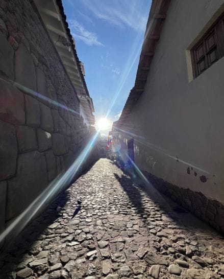 Sunlight shining through Triunfo Street in Cusco