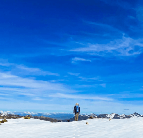 A turquoise lake surrounded by snow-dusted peaks along the Ausangate trail.