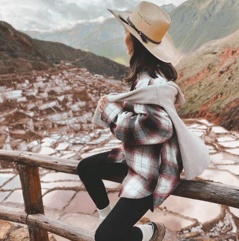 Agricultural terraces and stone ruins in the Sacred Valley with dramatic mountain backdrops.