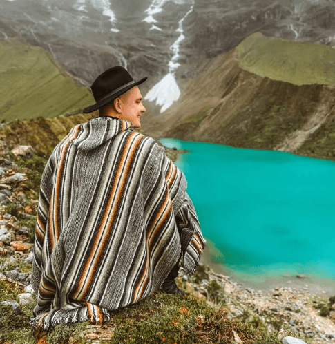 Turquoise-blue Humantay Lake nestled beneath a snow-capped mountain peak.