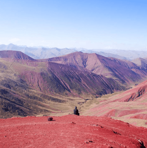 The colorful ridges of Wilcacunca Rainbow Mountain under a clear blue sky, with no crowds in sight.