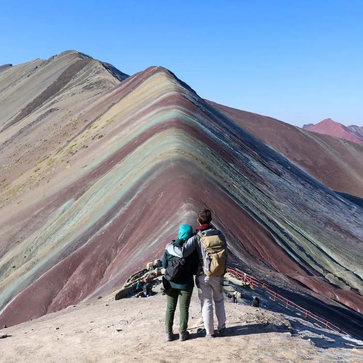 a couple in front of the Rainbow Mountain 