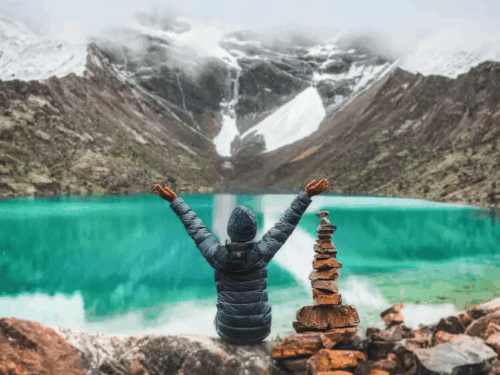 Turquoise Humantay Lake surrounded by snow-capped Andes mountains