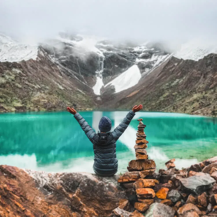 Turquoise Humantay Lake surrounded by snow-capped Andes mountains