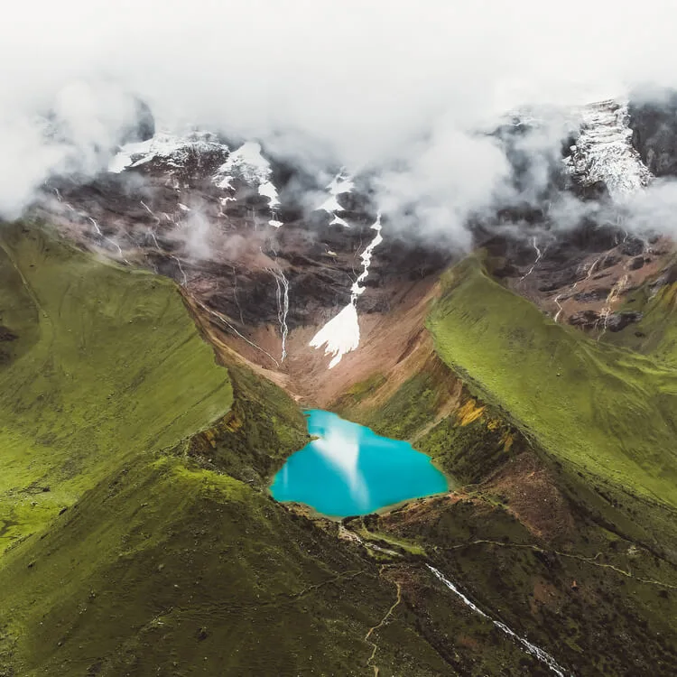 Humantay Lake reflecting cloudy skies during the rainy season
