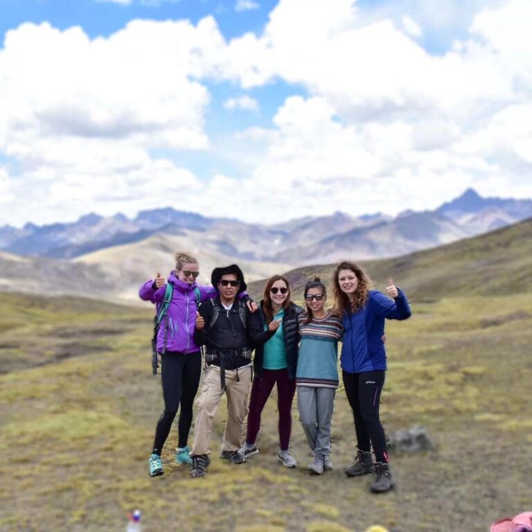 a family posing during their trek of the Rainbow Mountains