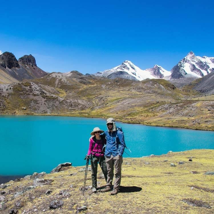 a couple ready to trek the Rainbow Mountain in their trekking gear