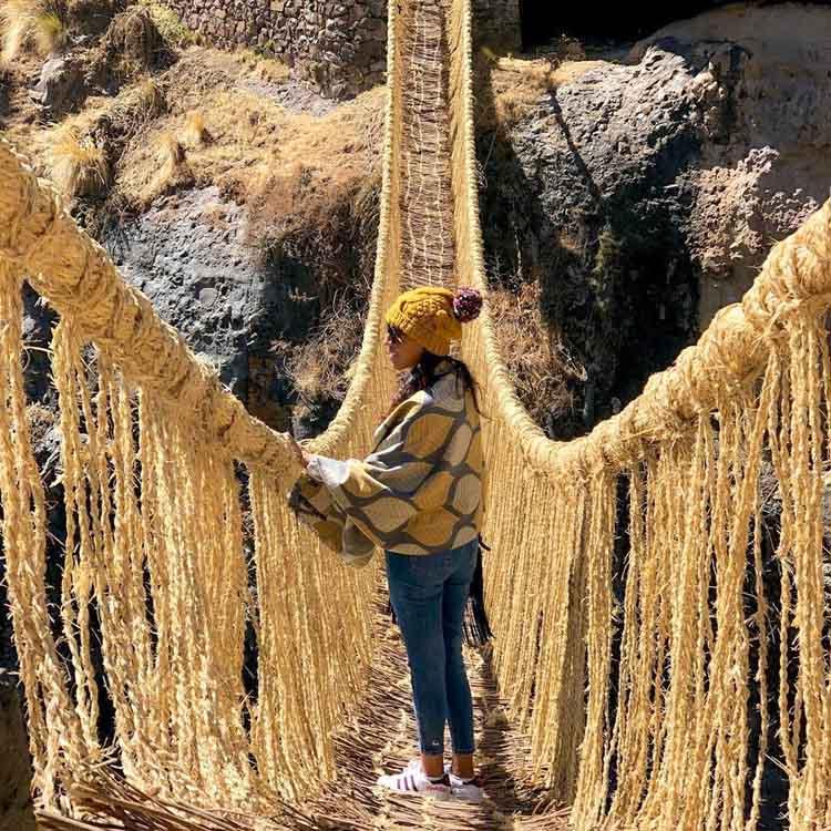 a girl crossing the Inca bridge
