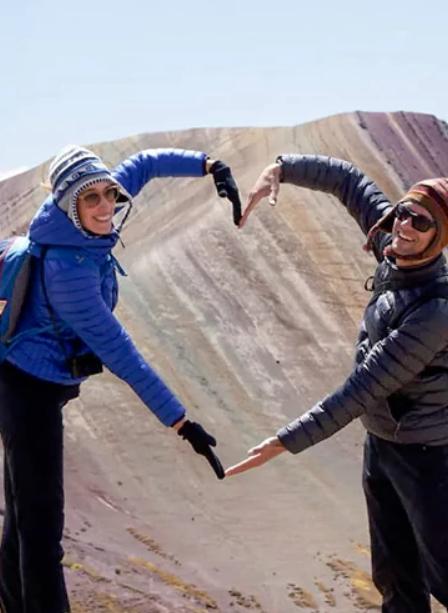Two people making the sign of a heart