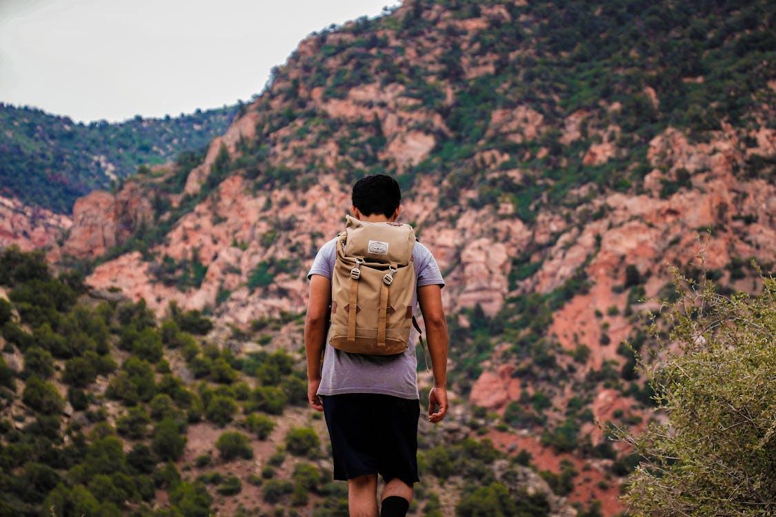 A person standing at the edge of a mountain