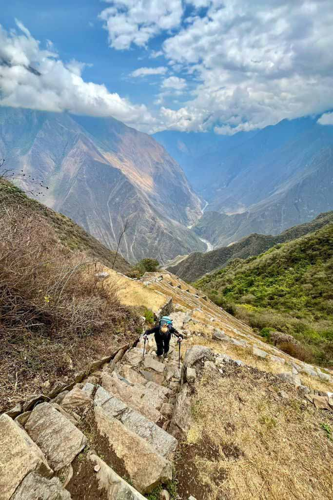a person wearing trekking gear trekking up the Choquequirao route