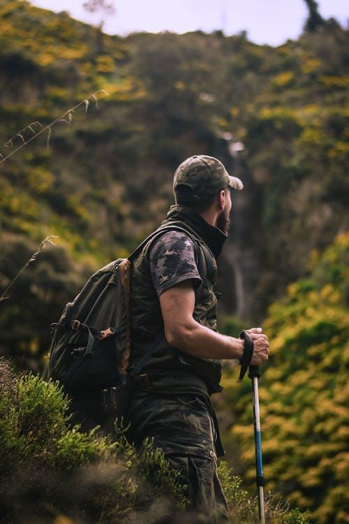 A person standing and taking a break from trekking