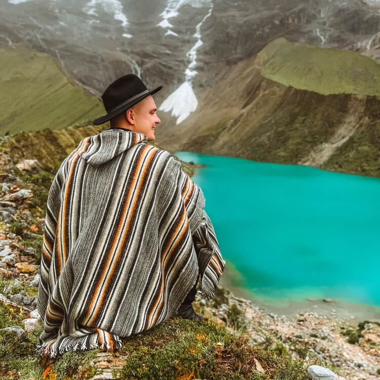  a person sitting by the Humantay Lake